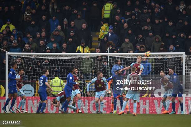 Burnley's English striker Ashley Barnes falls to the ground after a clash with Everton's English-born Welsh defender Ashley Williams, who is...