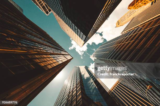 low angle view of the skyscrapers in nyc - prédios imagens e fotografias de stock