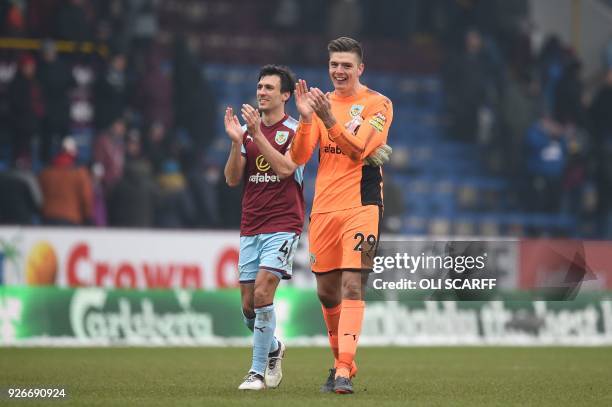 Burnley's English midfielder Jack Cork and Burnley's English goalkeeper Nick Pope applaud supporters on the pitch after the English Premier League...