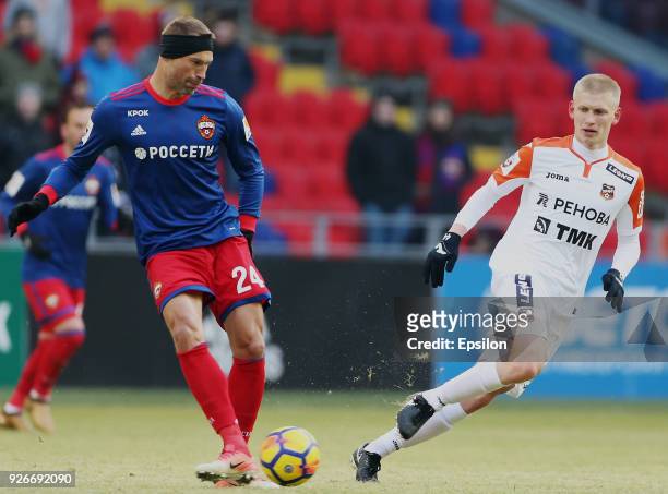 Vasili Berezutski of PFC CSKA Moscow vies for the ball with Gregor Balazhints of FC Ural Ekaterinburg during the Russian Premier League match between...