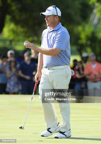 George Coetzee of South Africa acknowledges the crowd on the 18th green during the third round of the Tshwane Open at Pretoria Country Club on March...