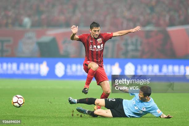 Odil Ahmedov of Shanghai SIPG and Zhou Ting of Dalian Yifang compete for the ball during the 2018 Chinese Football Association Super League first...
