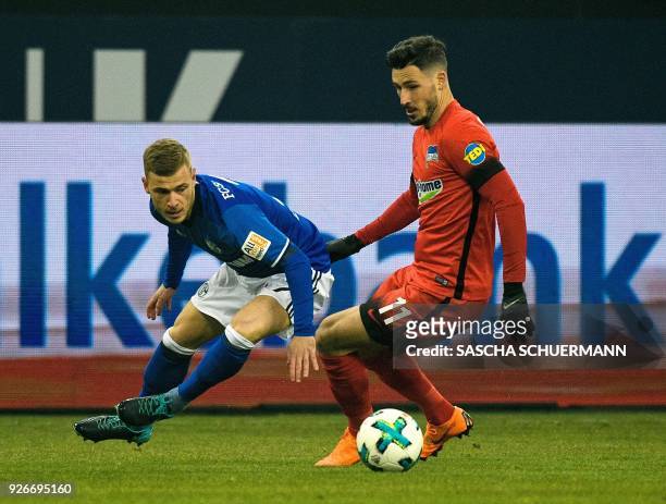 Schalke's German midfielder Max Meyer and Berlin's Australian midfielder Mathew Leckie vie for the ball during the German first division Bundesliga...