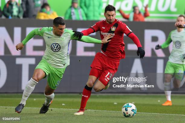 Jeffrey Bruma of Wolfsburg battles for the ball with Lucas Alario of Leverkusen during the Bundesliga match between VfL Wolfsburg and Bayer 04...