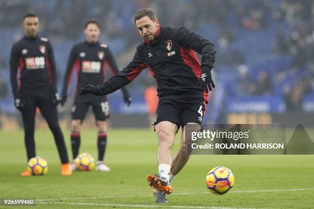 Bournemouth's English midfielder Dan Gosling warms up ahead of the English Premier League football match between Leicester City and Bournemouth at...