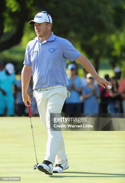 George Coetzee of South Africa acknowledges the crowd on the 18th green during the third round of the Tshwane Open at Pretoria Country Club on March...