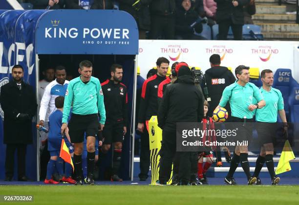 Match officials Andy Garratt, Lee Probert, and Marc Perry lead the teams out prior to the Premier League match between Leicester City and AFC...