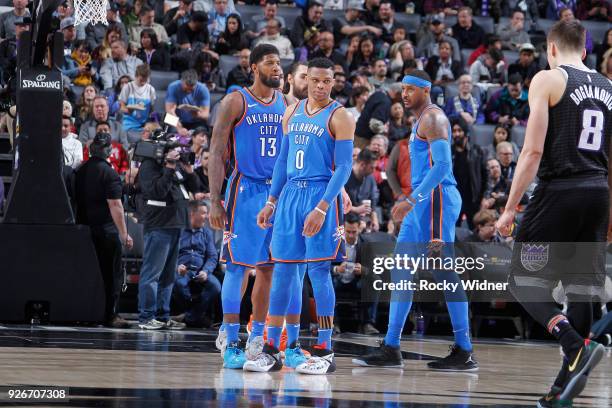 Paul George, Russell Westbrook and Carmelo Anthony of the Oklahoma City Thunder face the Sacramento Kings on February 22, 2018 at Golden 1 Center in...
