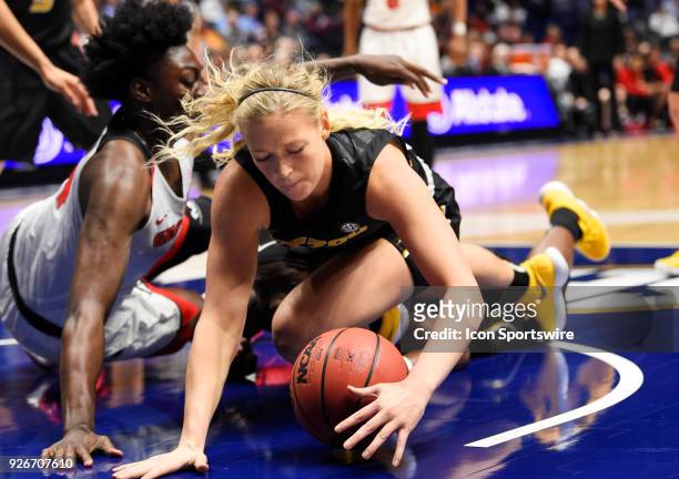Missouri Tigers guard Lauren Aldridge and Georgia Bulldogs guard Gabby Connally fight for the loose ball during the first period between the Georgia...