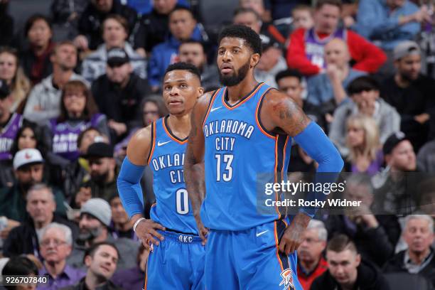 Russell Westbrook and Paul George of the Oklahoma City Thunder face the Sacramento Kings on February 22, 2018 at Golden 1 Center in Sacramento,...