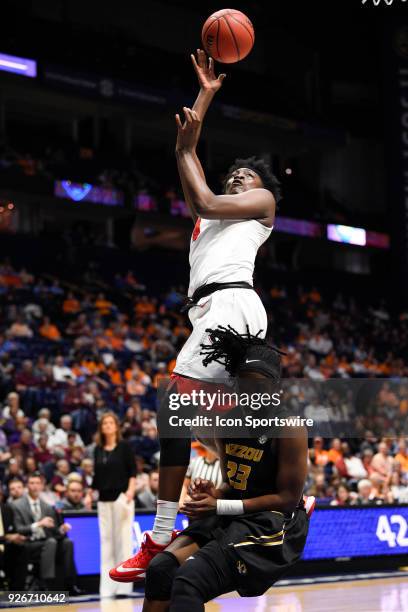 Georgia Bulldogs forward Caliya Robinson twist to make a shot over Missouri Tigers guard Amber Smith during the second period between the Georgia...