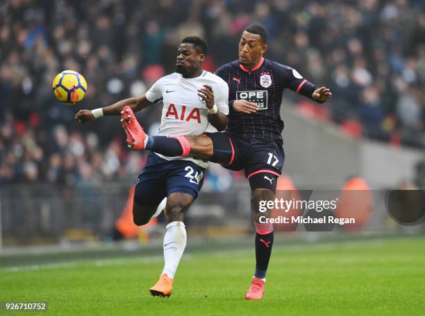 Rajiv van La Parra of Huddersfield Town challenges Serge Aurier of Tottenham Hotspur during the Premier League match between Tottenham Hotspur and...