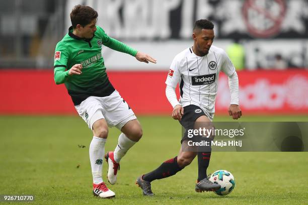 Jonathan de Guzman of Frankfurt is chased by Pirmin Schwegler of Hannover during the Bundesliga match between Eintracht Frankfurt and Hannover 96 at...