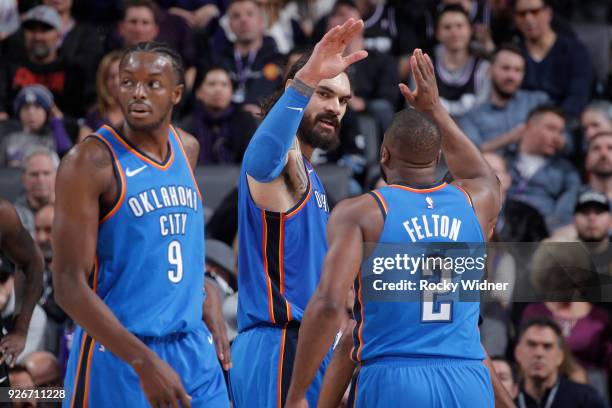 Steven Adams and Raymond Felton of the Oklahoma City Thunder high five during the game against the Sacramento Kings on February 22, 2018 at Golden 1...