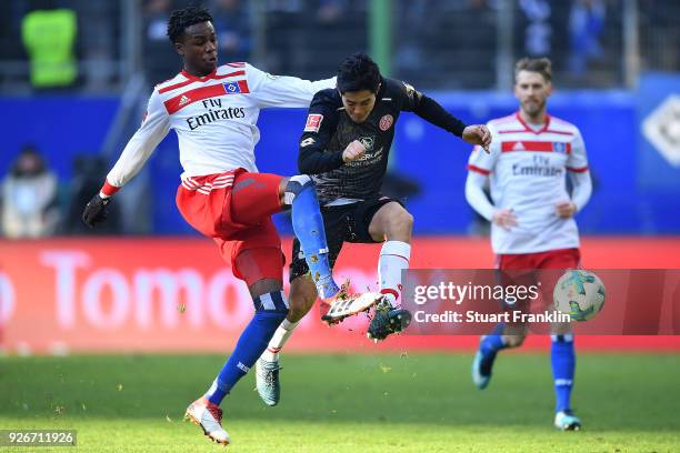 Gideon Jung of Hamburg fights for the ball with Yoshinori Muto of Mainz during the Bundesliga match between Hamburger SV and 1. FSV Mainz 05 at...