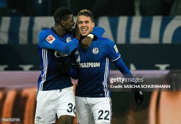 Schalke's Croatian midfielder Marko Pjaca is congratulated by his teammate Schalke's Swiss forward Breel Embolo after scoring the 1-0 during the...