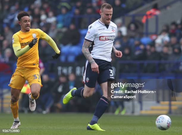 Preston North End's Callum Robinson chases down Bolton Wanderers' David Wheater during the Sky Bet Championship match between Bolton Wanderers and...