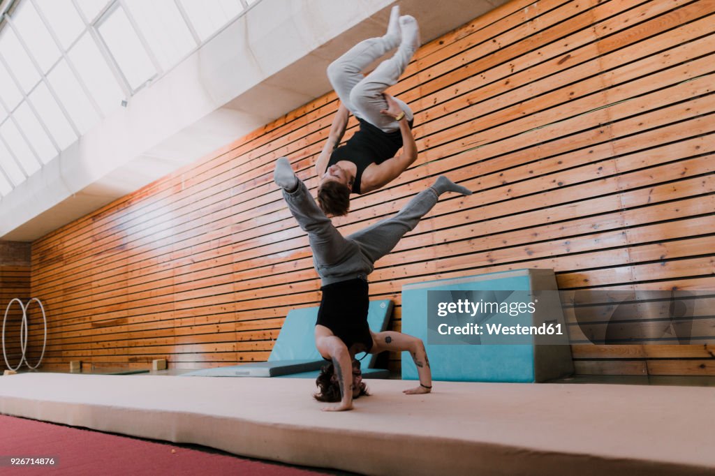 Practised Acrobatics Two Men Doing Acrobatics In Gym High-Res Stock Photo - Getty Images
