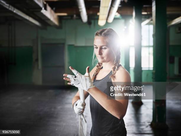 female martial artist preparing for a fight - woman fighter stock-fotos und bilder