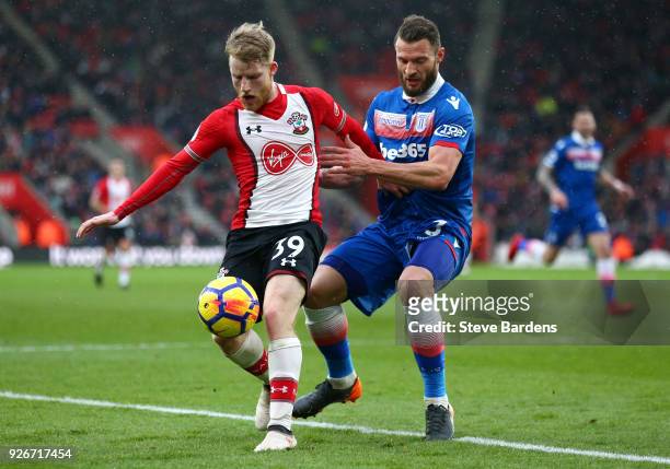 Josh Sims of Southampton is challenged by Erik Pieters of Stoke City during the Premier League match between Southampton and Stoke City at St Mary's...