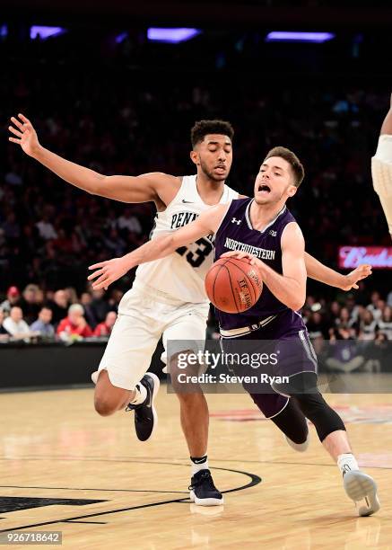 Bryant McIntosh of the Northwestern Wildcats is defended by Josh Reaves of the Penn State Nittany Lions during the second round of the Big Ten...