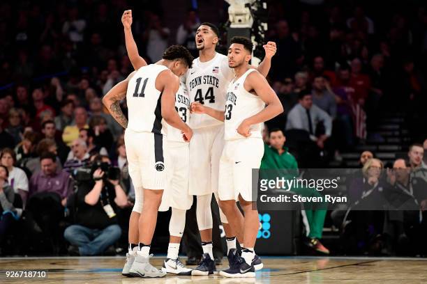 Tony Carr, Lamar Stevens, Shep Garner and Josh Reaves of the Penn State Nittany Lions huddle late in the game against the Northwestern Wildcats...