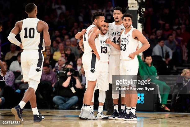 Tony Carr, Lamar Stevens, Shep Garner, Julian Moore and Josh Reaves of the Penn State Nittany Lions huddle late in the game against the Northwestern...