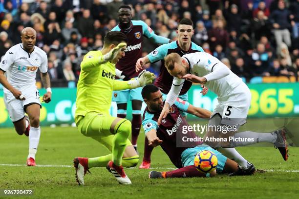 Winston Reid of West Ham falls on the ground during a challenge between Adrian of West Ham and Mike van der Hoorn of Swansea City during the Premier...