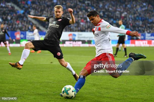 Douglas Santos of Hamburg shoots past Daniel Brosinski of Mainz during the Bundesliga match between Hamburger SV and 1. FSV Mainz 05 at...