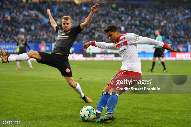 Douglas Santos of Hamburg shoots past Daniel Brosinski of Mainz during the Bundesliga match between Hamburger SV and 1. FSV Mainz 05 at...