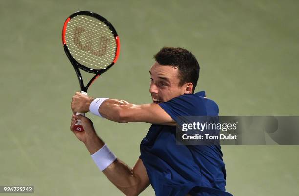 Roberto Bautista Agut of Spain plays a backhand during his final match against Lucas Pouille of France on day six of the ATP Dubai Duty Free Tennis...
