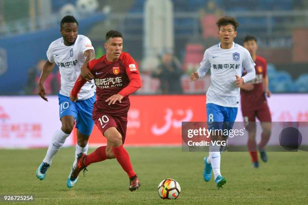 John Obi Mikel of Tianjin Teda and Hernanes of Hebei China Fortune compete for the ball during the 2018 Chinese Football Association Super League...