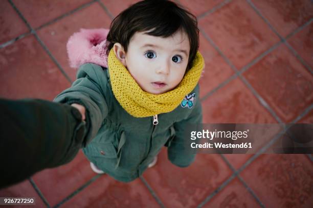 portrait of little girl holding mother's hand looking up - child and unusual angle stock pictures, royalty-free photos & images