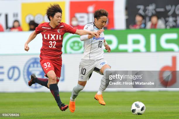 Koki Anzai of Kashima Antlers and Shu Kurata of Gamba Osaka compete for the ball during the J.League J1 match between Kashima Antlers and Gamba Osaka...
