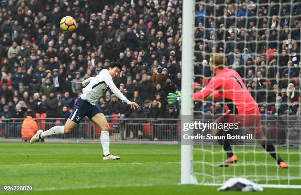 Heung-Min Son of Tottenham Hotspur scores their second goal past Jonas Loessl of Huddersfield Town during the Premier League match between Tottenham...