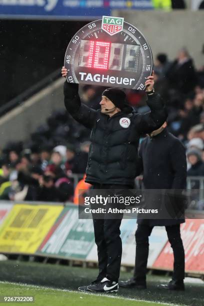 The fourth official shows 10 minutes of extra time during the Premier League match between Swansea City and West Ham United at The Liberty Stadium on...