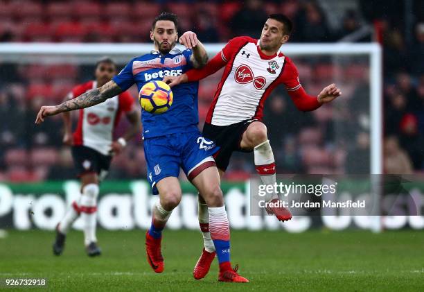 Geoff Cameron of Stoke City and Dusan Tadic of Southampton battle for the ball during the Premier League match between Southampton and Stoke City at...