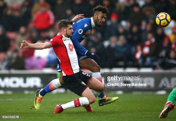 Maxim Choupo-Moting of Stoke City shoots and misses as he is chased by Jack Stephens of Southampton during the Premier League match between...