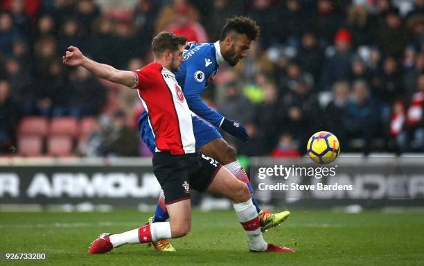 Maxim Choupo-Moting of Stoke City shoots and misses as he is chased by Jack Stephens of Southampton during the Premier League match between...