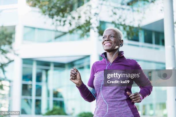 senior african-american woman exercising outdoors - old woman running stock pictures, royalty-free photos & images