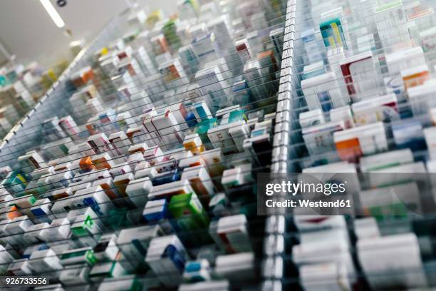 medicine in shelves in commissioning machine in pharmacy - treatment stock-fotos und bilder