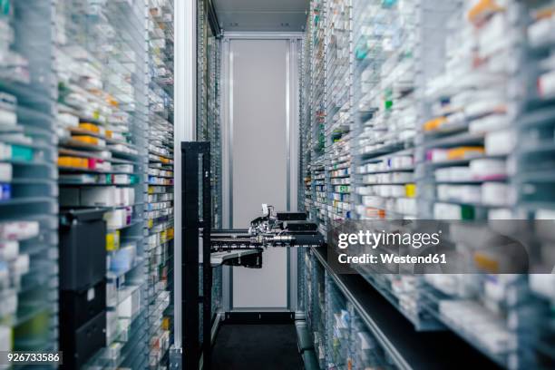 medicine in shelves in commissioning machine in pharmacy - health system stock-fotos und bilder