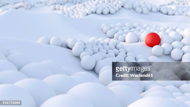 red ball among big group of white spheres - red sphere stock illustrations