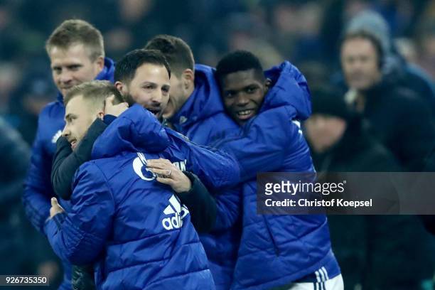 Head coach Domenico Tedesco of Schalke embraces Max Meyer after winning 1-0 the Bundesliga match between FC Schalke 04 and Hertha BSC at...