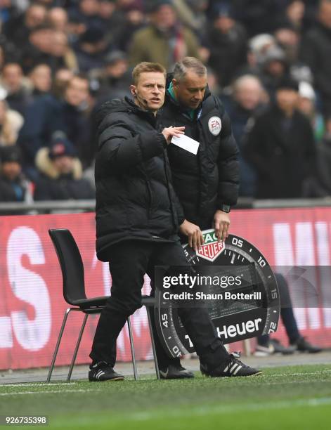 Injured referee Mike Jones is given assistance as he operates as fourth official during the Premier League match between Tottenham Hotspur and...