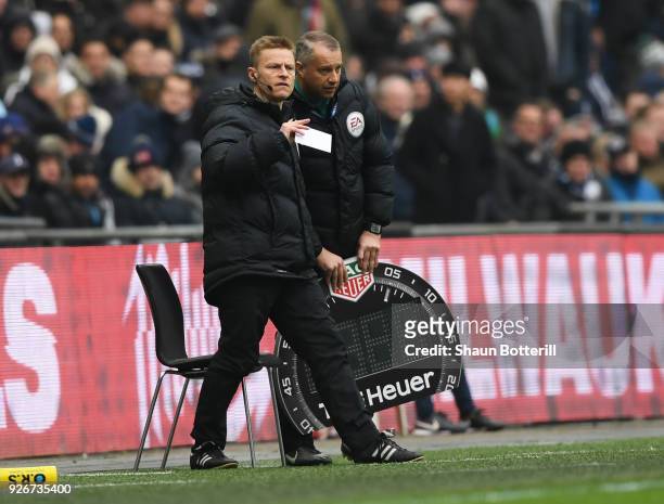Injured referee Mike Jones is given assistance as he operates as fourth official during the Premier League match between Tottenham Hotspur and...
