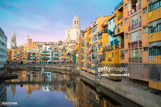 spain, catalunya, girona, cathedral and houses along the river onyar in the evening - girona stock pictures, royalty-free photos & images