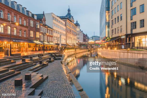 denmark, aarhus, view to lighted city with aarhus river - jutland stockfoto's en -beelden