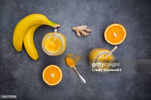 orange banana smoothie with ginger and curcuma - orange powder stock pictures, royalty-free photos & images