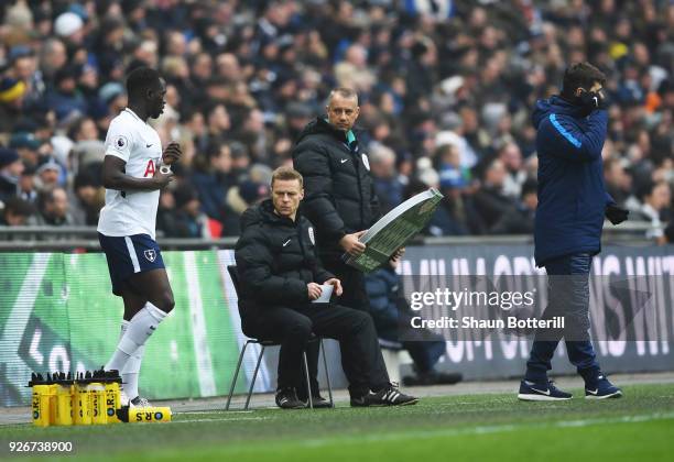 Injured referee Mike Jones is given assistance as he operates as fourth official during the Premier League match between Tottenham Hotspur and...